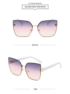 Detail of rimless cat eye sunglasses with gold metal frame and purple gradient lenses