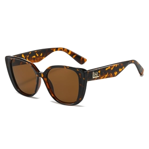 Stylish oversized cat eye tortoiseshell sunglasses with gold letter detail on the side