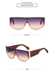 Detail view of golden large frame sunglasses with gray pink gradient lenses and tortoise legs