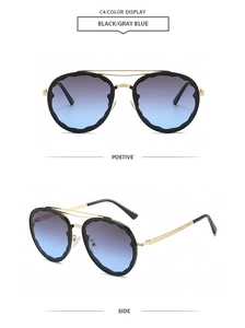 Detail of round sunglasses with black wavy scalloped frames and gray-blue gradient lenses