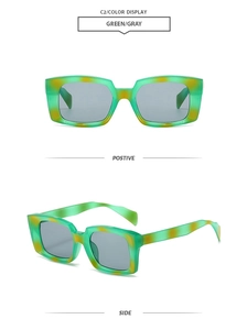 Close-up of retro rectangle green and gray tortoiseshell sunglasses with dark gray lenses