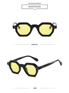 Detail view of retro geometric polygon sunglasses featuring black frames and yellow lenses