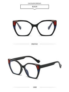 Detail of square oversized black sunglasses with red, blue, and brown geometric color blocks