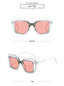 Detail view of square transparent gray frame sunglasses with light pink tinted lenses