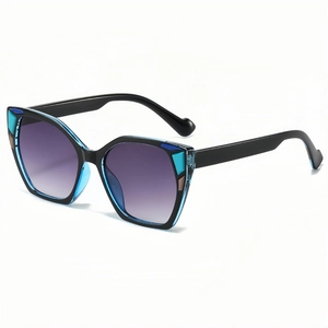 Oversized cat-eye sunglasses with blue-black frame and purple gradient lenses