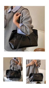 Détail du sac cabas en cuir noir avec surpiqûres blanches contrastées et boucle métallique chic