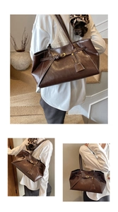 Détail d'un sac cabas marron vintage avec coutures blanches et boucle décorative chic