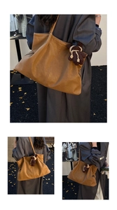 Detail of caramel tote bag with pebble texture leather and cute brown bear pendant charm