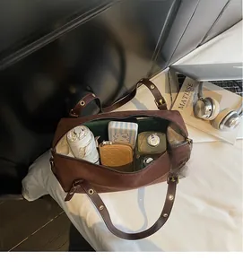 Interior view showing the large capacity of the brown suede cylinder shoulder bag