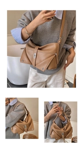 Detail view of brown textured leather tote with unique folding bow design and silver hardware