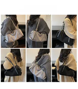 Detail view of versatile canvas shoulder bags in grey and black with adjustable straps