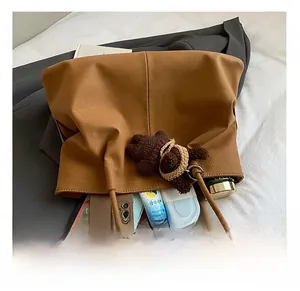 Detail view of large brown tote bag showing spacious interior with daily essentials