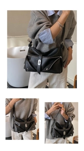 Close-up of black lychee grain leather shoulder bag with decorative silver metal zippers