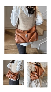 Detail of caramel brown tote bag showing litchi grain leather and multi-zipper pockets