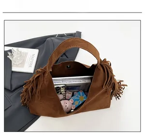 Internal view of large brown suede tote bag showing capacity for tablets and notebooks