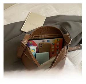 Macro view of large capacity interior for brown litchi pattern tote shoulder bag