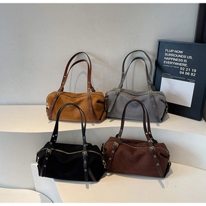 Detail of Boston tote bags in suede finish featuring retro gold rivets and leather straps