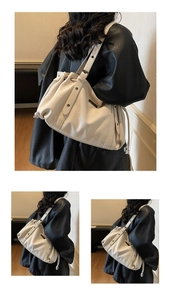 Detail of white lychee grain leather tote bag with drawstring and metal rivets
