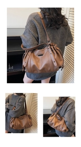 Detailed view of a brown pebbled leather tote bag with vintage metal buckle and pleats
