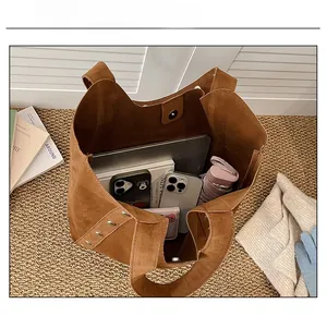 Large capacity tote bag showing spacious interior with laptop, umbrella and books