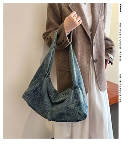 Detailed view of the large capacity washed denim shoulder bag with retro worn texture