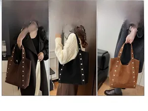 Close-up of minimalist suede tote bag with silver rivet details and multiple carry options