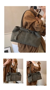 Close-up of minimalist dark grey tote bag with soft suede texture and slim shoulder straps
