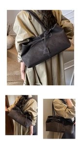 Close-up of deep brown tote bag showing matte texture and bow ribbon decoration