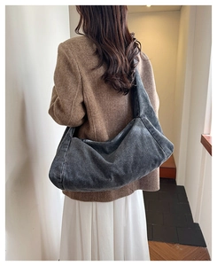 Deep grey denim shoulder bag with casual oversized slouchy design on a female model