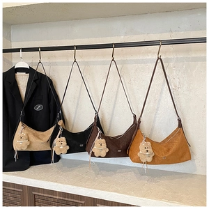 Detailed display of four textured vintage tote bags in beige black and brown tones