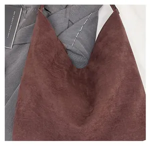 Close-up of deep brown suede tote bag featuring large capacity and soft hobo texture