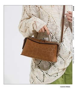 Close-up of leopard print shoulder bag with silver zipper and refined texture detail