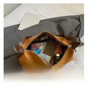 Interior view of mustard yellow tote bag showing large capacity and wrinkled PU texture