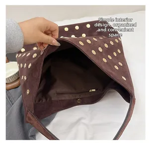 Top-down view of large brown suede tote bag featuring interior zipper pocket and gold rivets