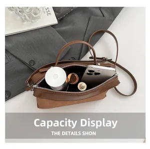 Top view of brown leather bag interior showing large capacity for phone and cosmetics