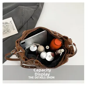 Large brown tote bag interior capacity display showing tablet, phone, and daily essentials