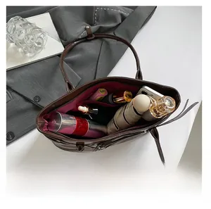 Interior view of brown patent leather tote bag showing large capacity for daily items
