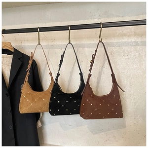 Retro hobo bags in suede featuring gold rivet diamond patterns and bow strap detail