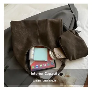 Detail of dark brown suede Hobo bag showing large capacity for tablet and cosmetics