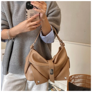 Detail of brown leather shoulder bag with motorcycle jacket style zipper and rivets