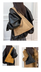 Detailed view of the wide shoulder strap featuring dual rows of metal eyelet rivets