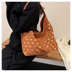 Detailed view of brown matte suede texture and gold rivets on a retro shoulder tote bag