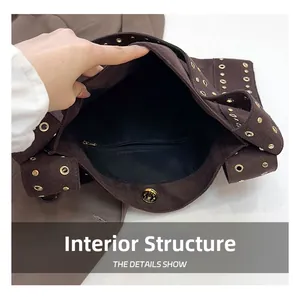 Detail view of the brown suede tote interior with a zipper pocket and magnetic closure