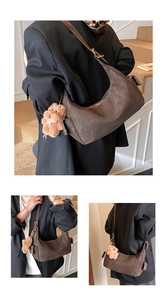 Detail of vintage brown matte hobo bag with adjustable strap and plush bear charm