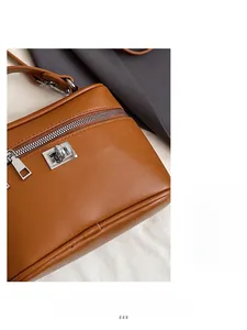 Close-up of brown vintage square bag featuring silver hardware and fine leather stitching