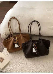 Brown and coffee suede tote bags displayed on a soft rug for a cozy autumn look