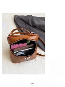 Top-down view of a brown bucket bag showing interior space for phone and wallet
