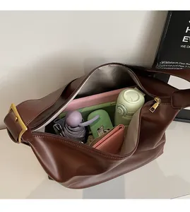 Spacious interior of the brown hobo bag showing capacity for tablet and daily items