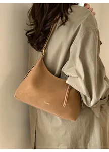 Detailed view of camel leather hobo bag with gold hardware and CLEAR K logo brand detail