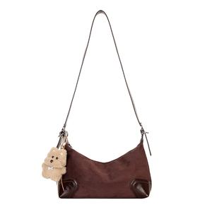 Brown minimalist crescent shoulder bag in suede and leather with plush bear charm